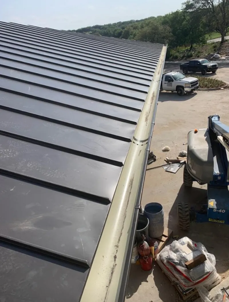 Standing seam panel and gutter detail on a metal roofing jobsite in Frankfort